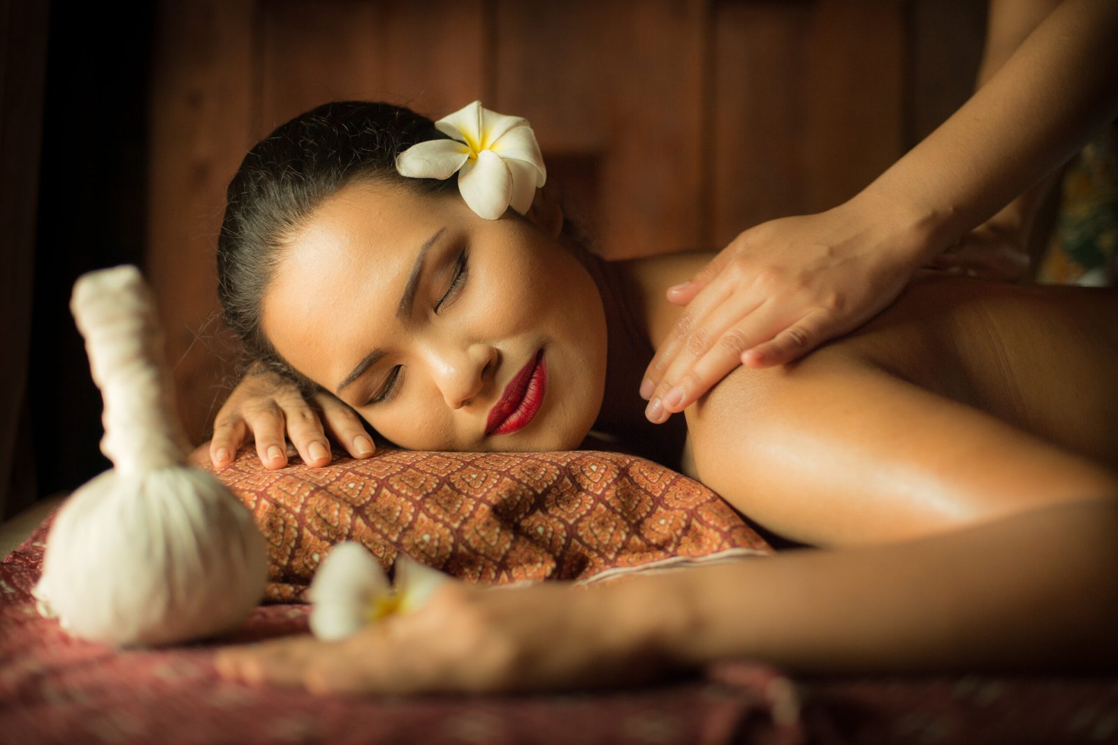 Masseur doing massage on Asian woman body in the spa salon